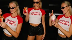 Woman in Hot Girls Eat Arby's shirt holding Arby's shake and fries