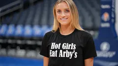 Woman wearing black shirt with Hot Girls Eat Arby's text in stadium